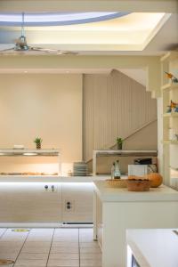 a kitchen with white cabinets and a staircase at Bali Beach and Sofia Village in Bali
