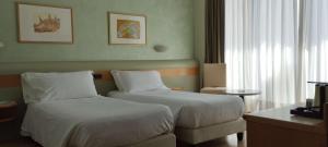 Posteľ alebo postele v izbe v ubytovaní Hotel Leonardo da Vinci