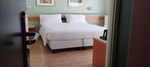 Posteľ alebo postele v izbe v ubytovaní Hotel Leonardo da Vinci