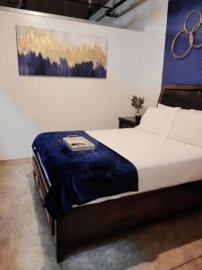 a bedroom with a bed with a blanket on it at Staycation City Loft Free Gated Parking in Saint Louis