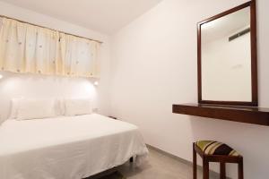 a bedroom with a bed with a mirror and a chair at Riviera Peace in Playa del Cura +33 photos