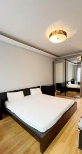 um quarto com uma grande cama branca num quarto em Prime Comfort Apartment with Balcony & Free Parking em Berlim