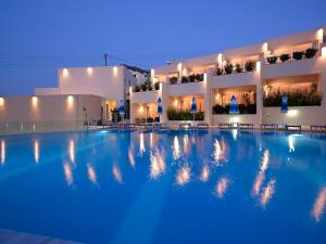 a large swimming pool in front of a building at Bali Beach and Sofia Village in Bali