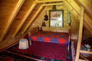 an attic room with a bed in the attic at Etno vodenica Ćirović - Ethno Watermill in Pljevlja +67 photos