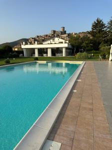 a swimming pool in front of a house at Il Casale di Riardo Luxury B&B in Riardo