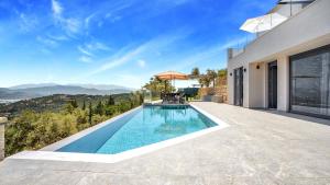 a swimming pool in the backyard of a house at Ecstasy Luxury Villas in Apolpaina