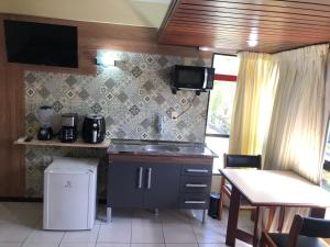 a kitchen with a sink and a counter top at Royal Service Hotel - Tambaú - ap 111 in João Pessoa