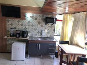 a kitchen with a sink and a counter top at Manos Flat Tambaú - ap 111 in João Pessoa