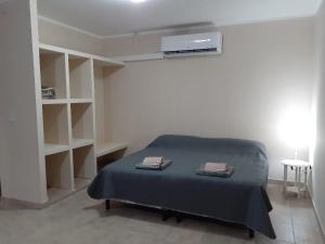 a bedroom with a bed with two towels on it at El Solar Departamentos Tartagal in Tartagal