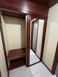 a walk in closet with mirrored doors in a room at Royal Service Hotel - Tambaú - ap 111 in João Pessoa