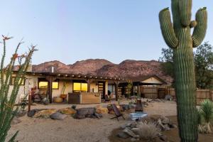 a house in the desert with a cactus at Peaceful Desert Paradise - Casa Coyote in Joshua Tree