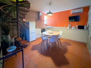 a kitchen with a table and chairs in it at São Jorge Country House in Penafiel