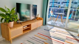 A television and/or entertainment centre at Stylish new apartment Calypso with pool&beach