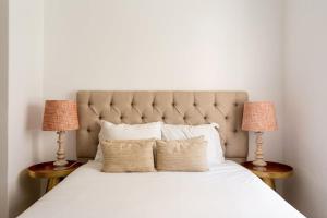 a bedroom with a large bed with two lamps at Central Bairro Alto in Lisbon