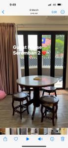 a table and two chairs in a room with a window at Rumah Tamu Sonata in Seremban +15 photos