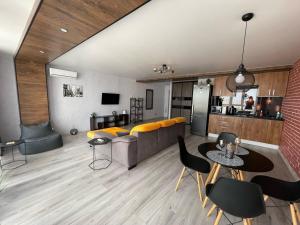 a living room with a couch and a table and chairs at Room1402 in Odesa