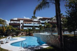 a swimming pool in front of a building at Luxury apartment with panoramic views - Marbella in Estepona