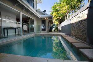 an image of a swimming pool in a house at 2/24 Donkin - Luxury - Absolute Beachfront in Mission Beach