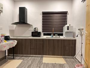 a kitchen with a sink and a window at Rumah Tamu Sonata in Seremban