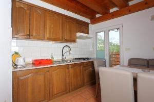 a kitchen with wooden cabinets and a sink at Apartment Brela 789a in Brela