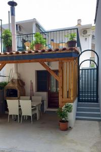 a patio with a table and chairs and a building at Apartments with a parking space Baska Voda, Makarska - 2609 in Baška Voda