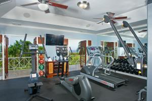 a gym with tread machines and a flat screen tv at Sunny Vacation Villa No 5 in Montego Bay