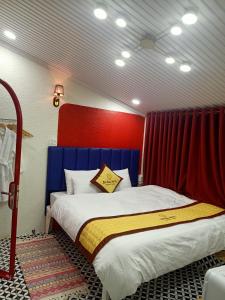 a bedroom with a bed with a red and blue headboard at Bich Ngoan HOTEL in Trà Vinh