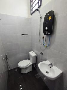 a bathroom with a toilet and a sink at Mukmin 2 Stay in Melaka