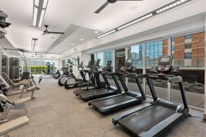a gym with a row of treadmills and ellipticals at Kasa Lady Bird Lake Austin in Austin