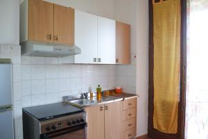 a kitchen with a sink and a stove at Appartamento La Chiusa in Monticiano