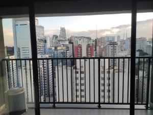 a view of a city skyline from a balcony at Studio de cobertura perto da av. Paulista in Sao Paulo
