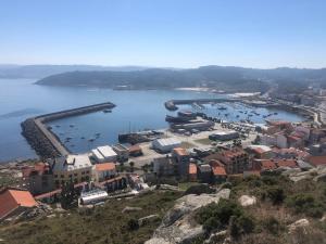 an aerial view of a harbor with boats in the water at As Politas in Muxia