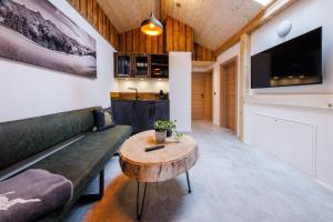 a living room with a couch and a table at Ferienhaus Froschsee in Ruhpolding