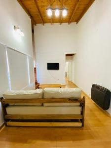 a room with two beds and a flat screen tv at La alegre! Hermosa casa centrica y cerca del mar in Puerto Madryn