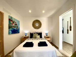 a bedroom with a large white bed and a mirror at Casa Pirilampo Ferragudo in Ferragudo