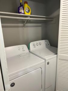 a small kitchen with a white washer and dryer at Beautiful 1-bedroom Townhome with nice amenities in Houston