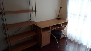 a desk and a chair in a room with a window at Painel da Caparica in Costa da Caparica