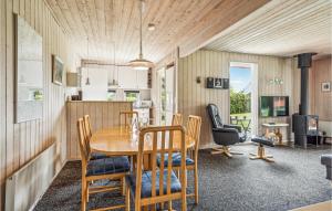 a kitchen and dining room with a wooden table and chairs at Gorgeous Home In Hejls With Kitchen in Hejls