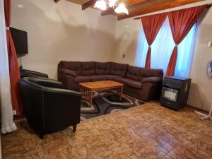 a living room with a couch and a table at Cabañas La Marca in San Pedro de Atacama