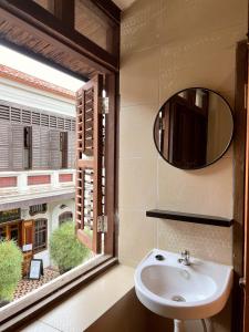 a bathroom with a sink and a large window at Aayu Stewart in George Town