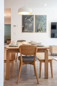 a wooden table with chairs and a dining room at Revy Bliss - Dazzling Condo in the Mountains in Revelstoke