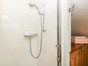 a shower in a bathroom with a glass door at Green Farm Cottage in Ashbourne +18 photos