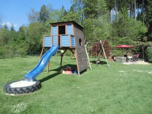 a play structure with a slide and a slideintend at Ferienhaus Matti in Kamschlacken