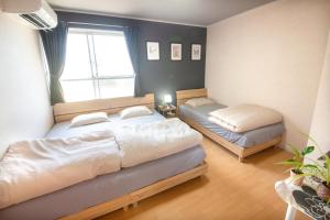 Postel nebo postele na pokoji v ubytování guesthouse みつば