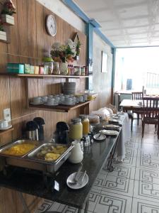 a kitchen with a buffet of food on a table at Pousada Ponta de Areia in Itaparica Town