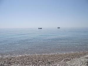 a beach with rocks and the water at B&B Il Mare degli Dei in Letojanni