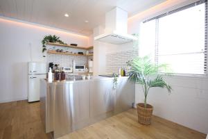 a kitchen with a sink and a refrigerator at BAYSIDE VILLA the Loose in Minamiawaji