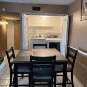 a kitchen with a table and chairs in a room at Lovely 2- bedroom apartment with nice amenities in Houston