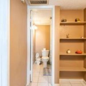 a bathroom with a toilet and a sink in it at Lovely 2- bedroom apartment with nice amenities in Houston