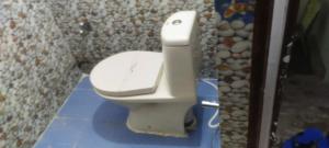 a bathroom with a toilet in a bathroom stall at SPOT ON Hotel Royal Garden in Dānāpur